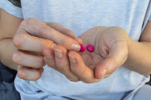pink pill in hand